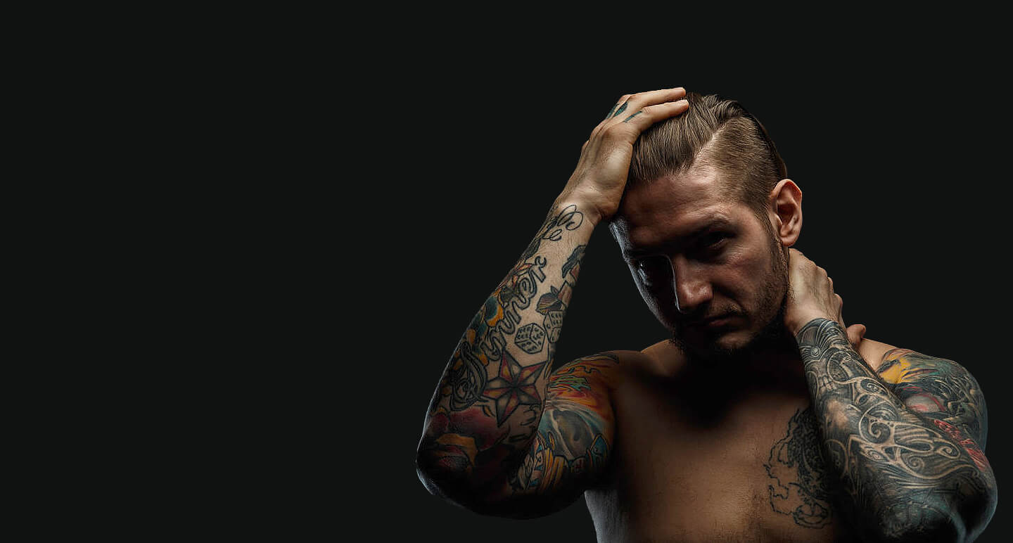 Man with unwanted sleeve tattoos considering laser tattoo removal